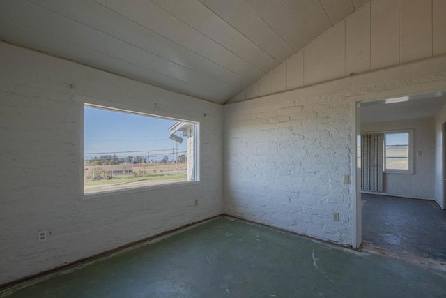 unfurnished room with vaulted ceiling