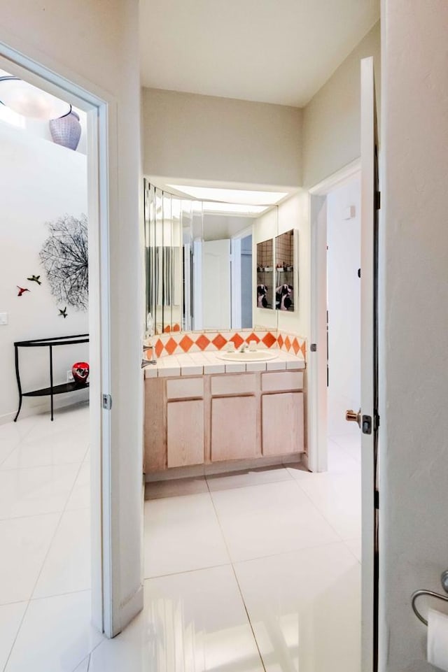 bathroom with tile patterned floors and vanity