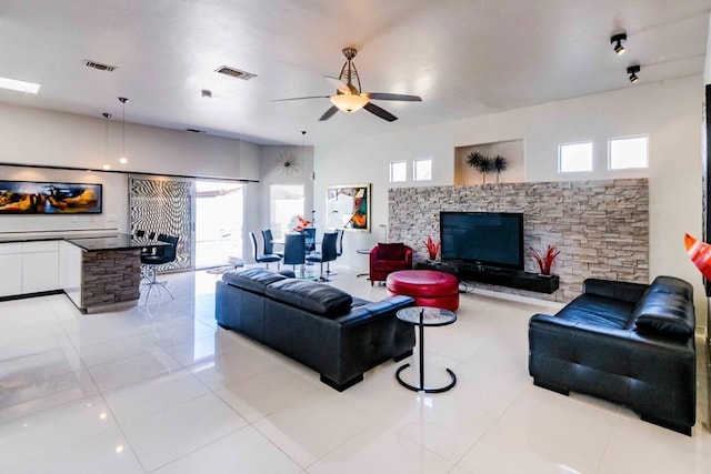 living room featuring light tile patterned flooring and ceiling fan