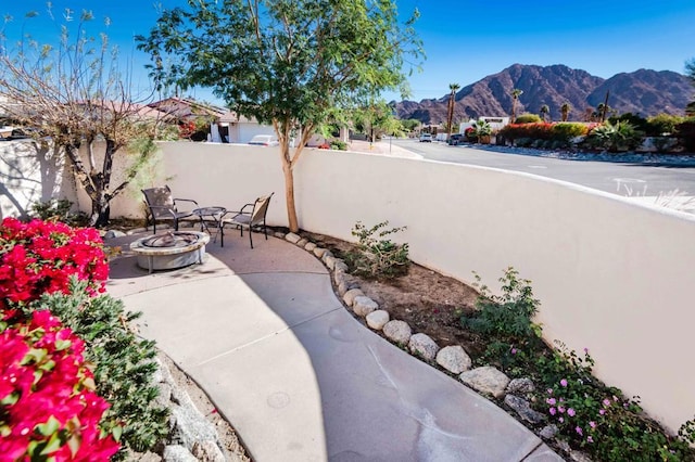 view of patio featuring a mountain view and an outdoor fire pit