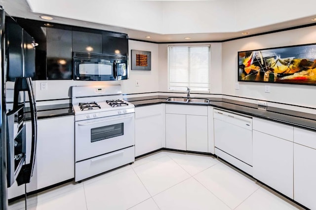 kitchen with white cabinetry, white appliances, sink, and light tile patterned floors