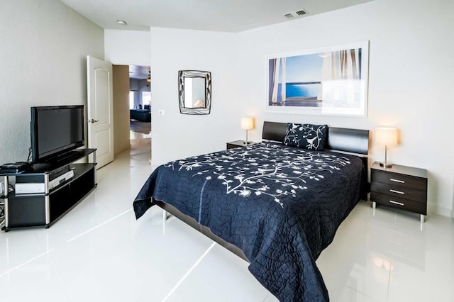 bedroom with light tile patterned floors