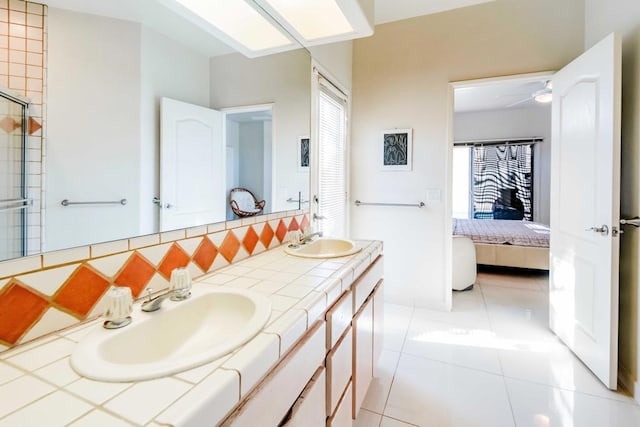 bathroom with tasteful backsplash, vanity, and tile patterned floors