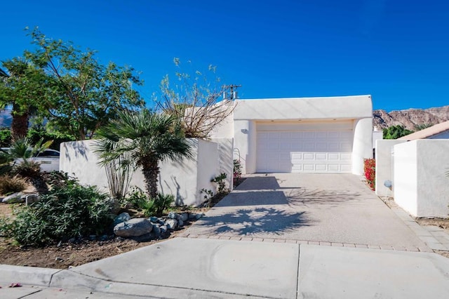 pueblo revival-style home with a garage