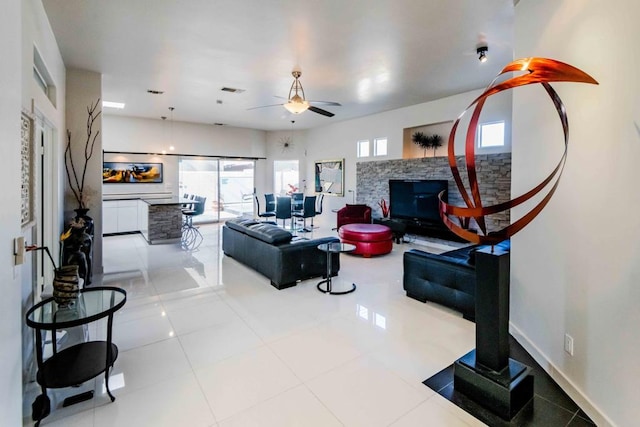 living room with ceiling fan and light tile patterned flooring