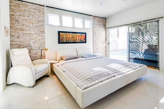 bedroom featuring multiple windows, light tile patterned floors, access to exterior, and ceiling fan