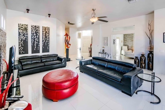 tiled living room with ceiling fan