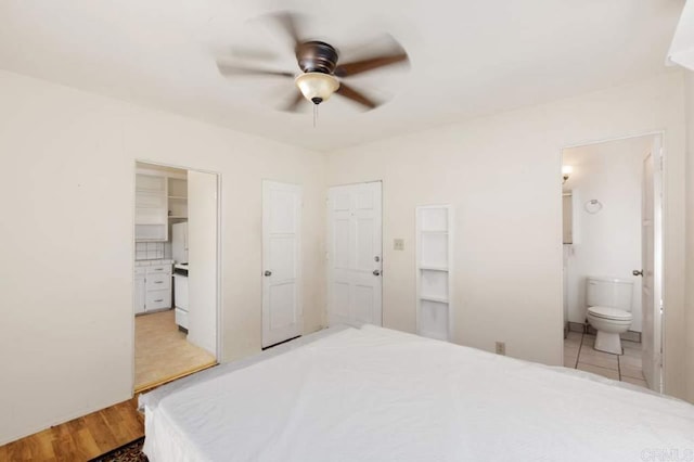 bedroom featuring a closet, ceiling fan, ensuite bathroom, and light hardwood / wood-style flooring