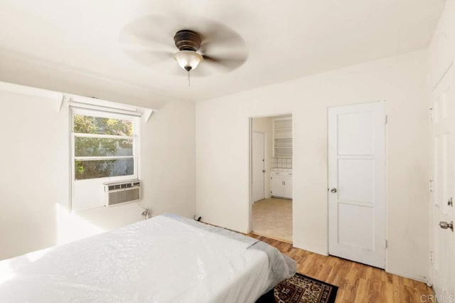 bedroom with ceiling fan, ensuite bathroom, and light hardwood / wood-style flooring