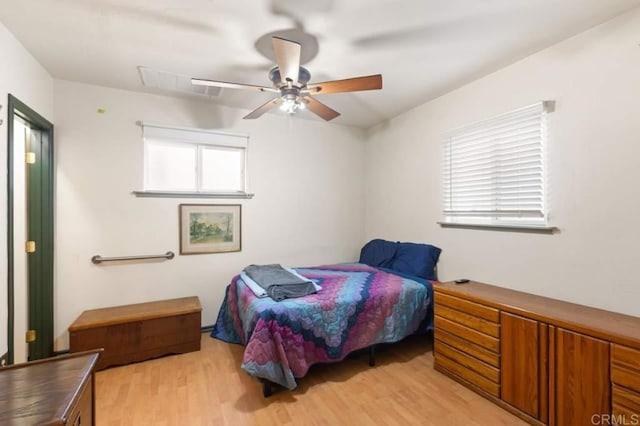 bedroom with ceiling fan and light hardwood / wood-style floors