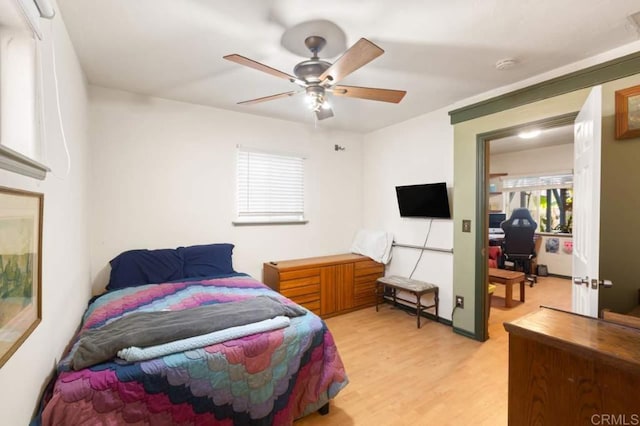 bedroom with ceiling fan and light hardwood / wood-style floors