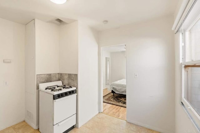 kitchen with white range with gas cooktop