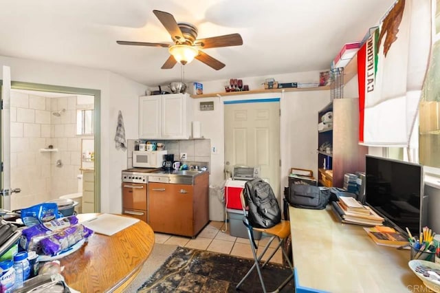 kitchen with ceiling fan, backsplash, white cabinetry, light tile patterned flooring, and stainless steel counters