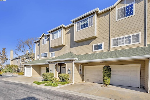 townhome / multi-family property featuring a garage