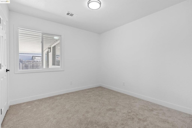 unfurnished room featuring light colored carpet