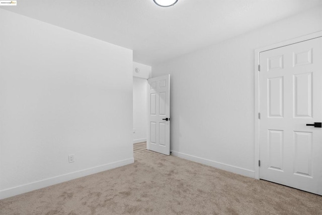 spare room with light colored carpet