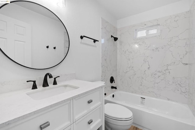 full bathroom featuring vanity, toilet, and tiled shower / bath