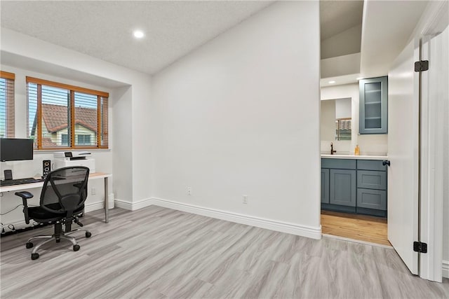 office space featuring sink and light hardwood / wood-style floors