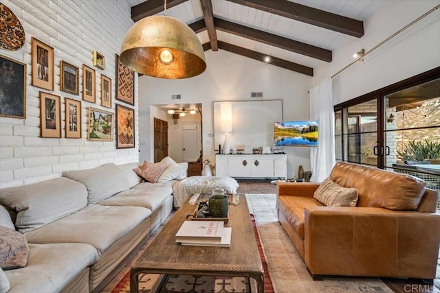 tiled living room featuring high vaulted ceiling, beam ceiling, and brick wall