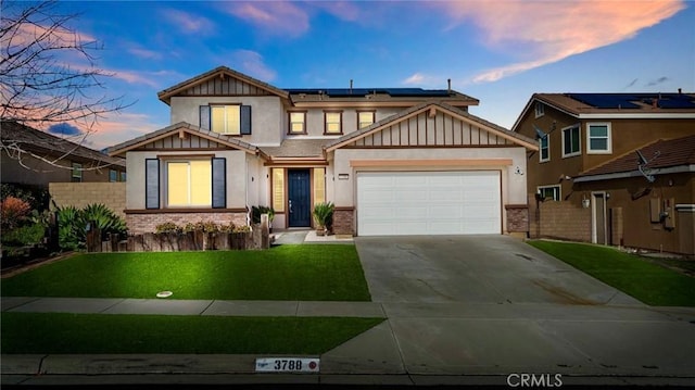 craftsman-style house featuring a garage, a yard, and solar panels