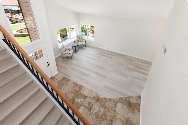 foyer featuring light hardwood / wood-style floors and high vaulted ceiling