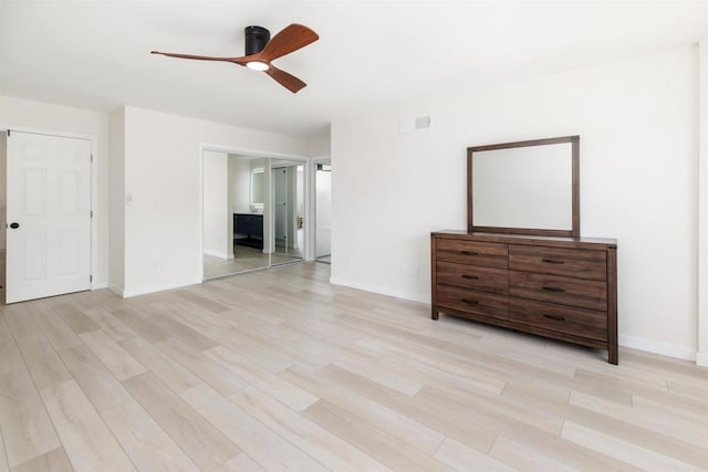 unfurnished bedroom with ceiling fan and light wood-type flooring