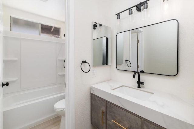 full bathroom featuring vanity, wood-type flooring, toilet, and washtub / shower combination