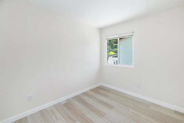 spare room featuring light wood-type flooring