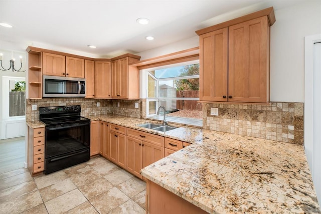 kitchen with black electric range oven, sink, an inviting chandelier, backsplash, and light stone countertops