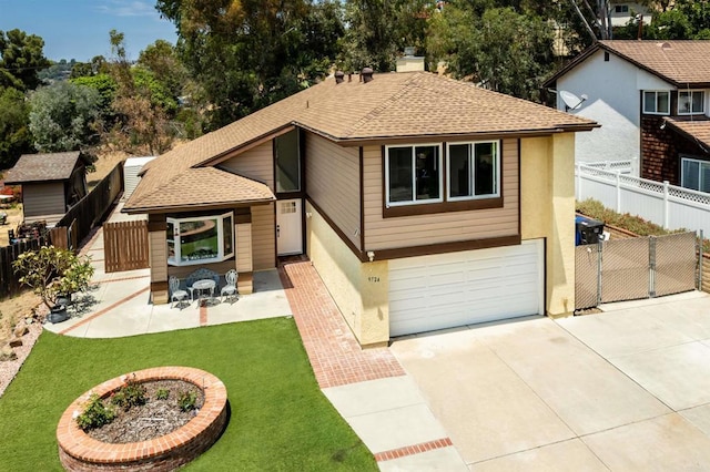 view of front of property with a garage, a patio, and a front yard