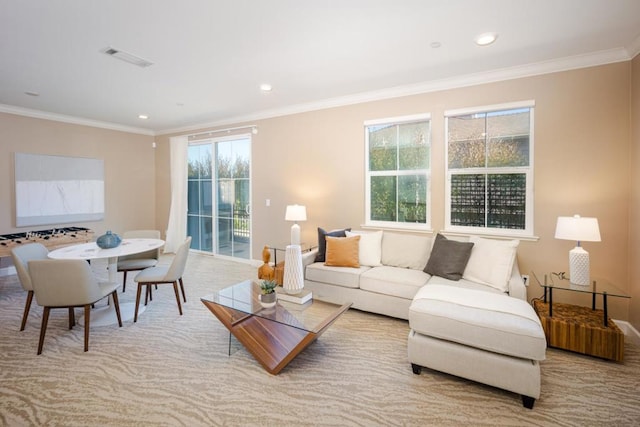 carpeted living room featuring ornamental molding