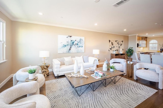 living room with ornamental molding and wood-type flooring