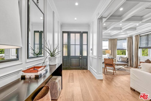 entrance foyer with crown molding, coffered ceiling, plenty of natural light, and beamed ceiling