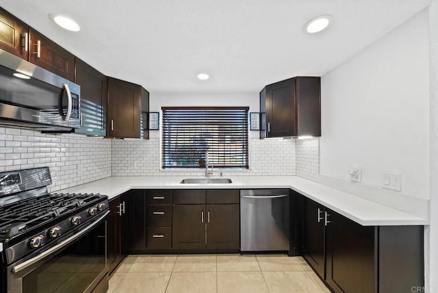 kitchen with sink, stainless steel appliances, light tile patterned floors, and decorative backsplash