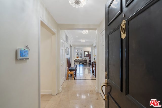 corridor featuring a chandelier