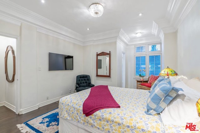 bedroom with ornamental molding and dark hardwood / wood-style floors