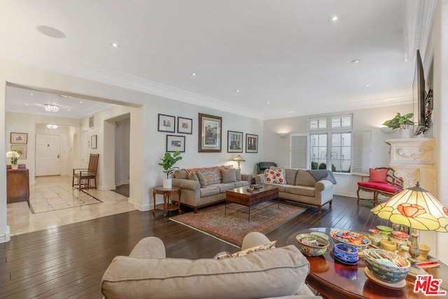 living room featuring ornamental molding and wood-type flooring