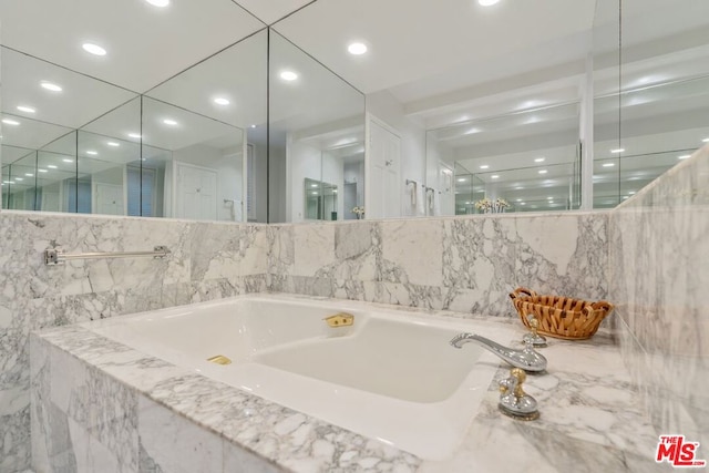 bathroom featuring tiled bath