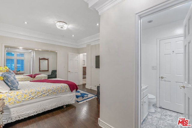 bedroom with light wood-type flooring, connected bathroom, and ornamental molding