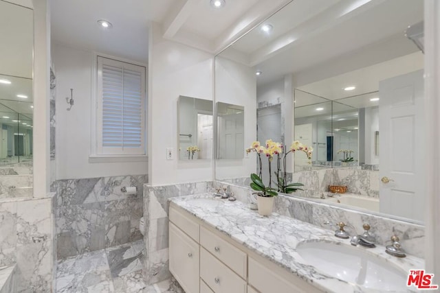 bathroom featuring vanity, toilet, and tile walls