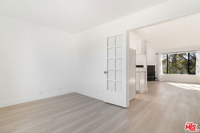 spare room with light wood-type flooring