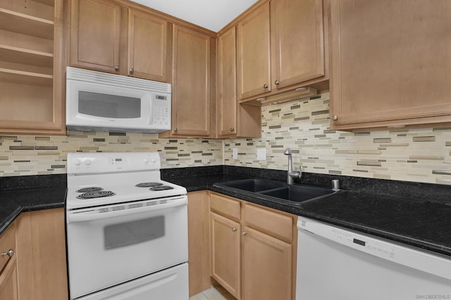 kitchen featuring sink, white appliances, decorative backsplash, and dark stone counters