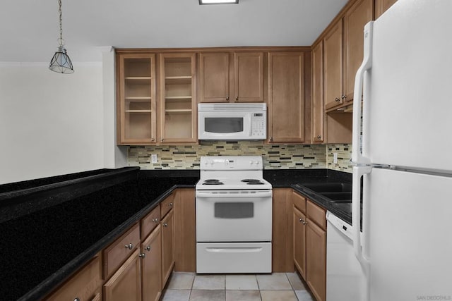 kitchen featuring white appliances, dark stone counters, pendant lighting, backsplash, and light tile patterned flooring