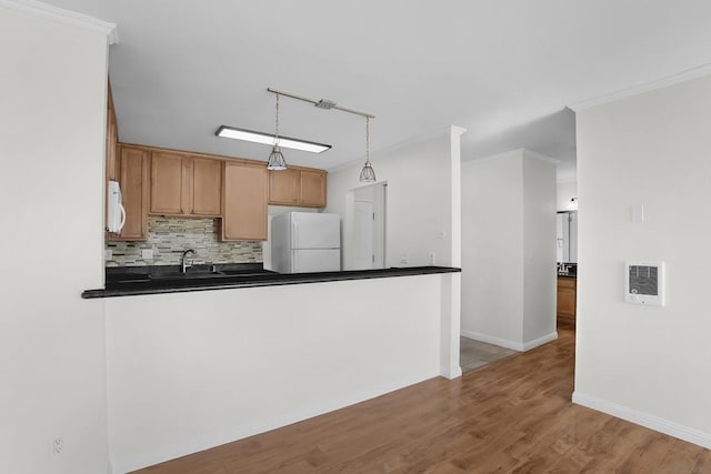 kitchen featuring pendant lighting, light wood-type flooring, white appliances, ornamental molding, and rail lighting