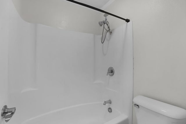 bathroom featuring toilet and shower / bathing tub combination