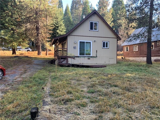 view of side of home featuring a yard