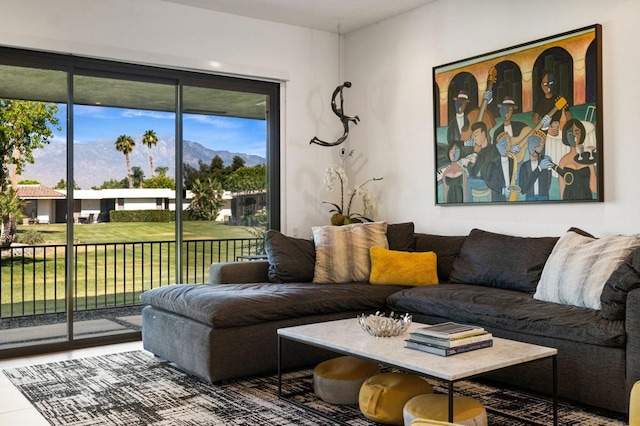 living room with a healthy amount of sunlight and a mountain view