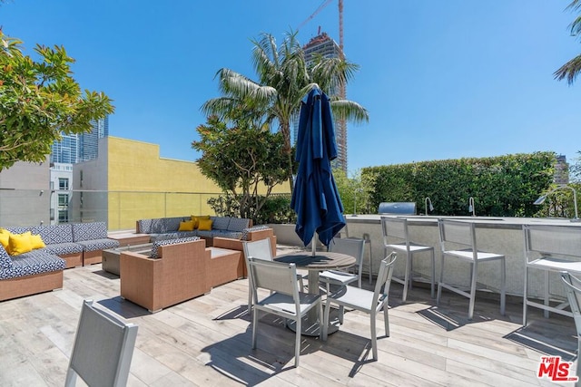 deck featuring an outdoor living space and exterior bar