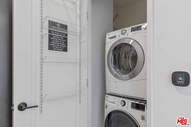 laundry area featuring stacked washing maching and dryer