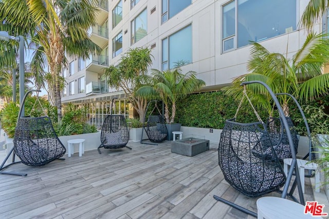 wooden terrace featuring a fire pit